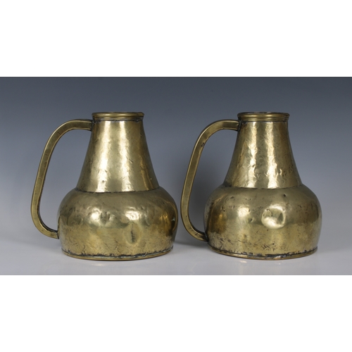 1147 - A pair of antique brass ale jugs23cm. high. (2)