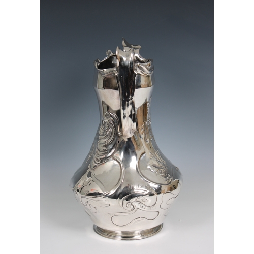 1162 - An Art Nouveau cast pewter vase, circa 1900, designed by J.R. Hannigdecorated with Irises and a maid... 