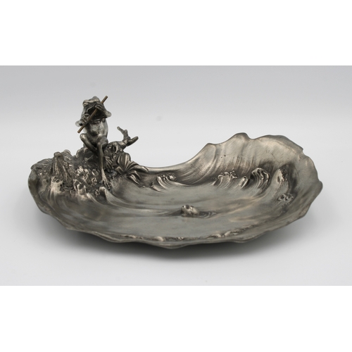 1165 - An Italian Art Nouveau pewter dishDesigned by Achille Gamba, depicting a frog playing the flute by a... 