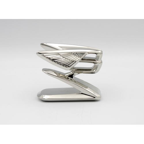 1069 - A chromium plated forward leaning double winged Bentley "B" car mascot6.5cm. high.