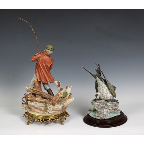 2009 - A Capodimonte porcelain figure of a fisherman with his dog, raised on gilt metal base, 34cm. high, w... 