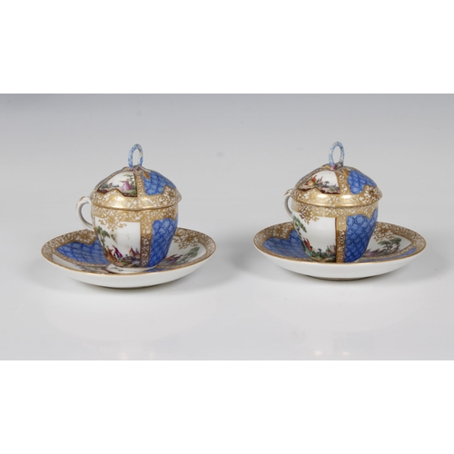 2118 - A pair of Continental Meissen style porcelain custard cups, decorated with country scenes with figur... 