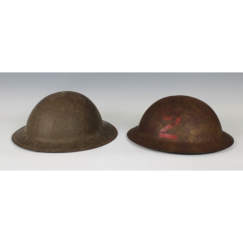 2150 - A brodie helmet with original insert and strap, stencil painted red letter 'Z' to front, together wi... 