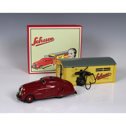 2318 - A Schuco No. 01070 garage with Commando tin plate and clockwork car, re-released example in the orig... 