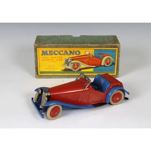 2360 - Meccano clockwork tinplate Two-Seater Sports Car, with red body and hubs and blue wheel arches, bump... 