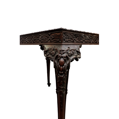 60 - A George III carved mahogany silver tablethe rectangular top with fretwork above a carved frieze on ... 