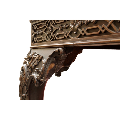 60 - A George III carved mahogany silver tablethe rectangular top with fretwork above a carved frieze on ... 