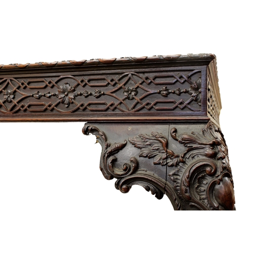 60 - A George III carved mahogany silver tablethe rectangular top with fretwork above a carved frieze on ... 