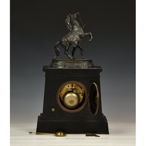 110 - A late 19th century slate and red marble mantel clock the French twin train movement striking the ho... 