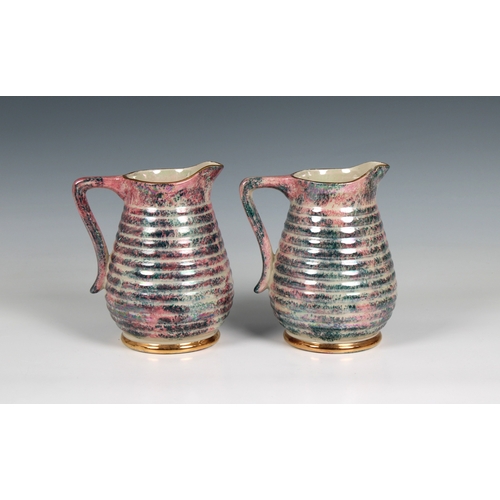 112 - A pair of 20th century Govancroft, Glasgow pottery lustre jugs mark beneath, 6 1/2 in. (16.5cm.) hig... 