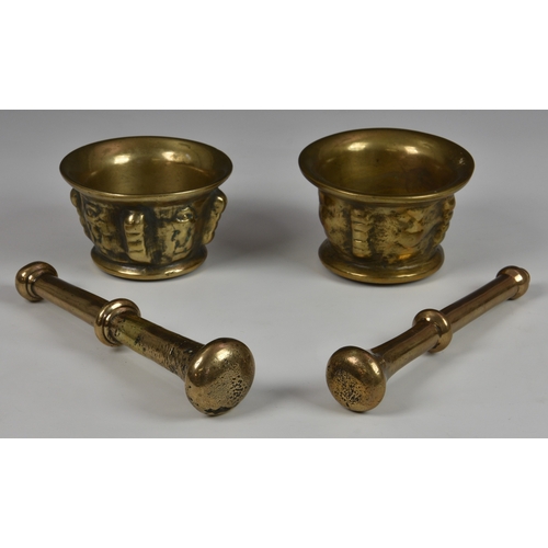 119 - Two polished bronze Eastern pestle and mortars each of similar typical form, the body with cast styl... 