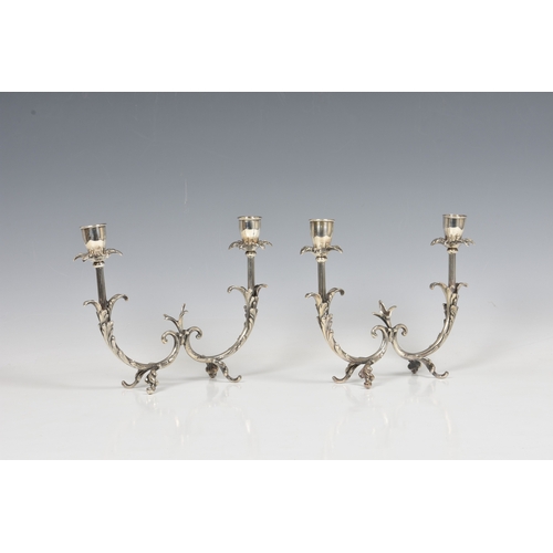 122 - A pair of Italian silver twin branch table candelabra stamped 800 and lozenge mark, having flower he... 