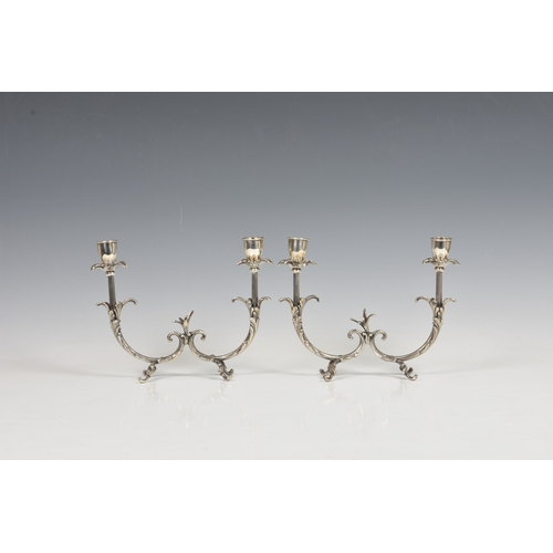 122 - A pair of Italian silver twin branch table candelabra stamped 800 and lozenge mark, having flower he... 