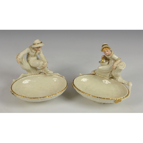 124 - A pair of Royal Worcester figural sweetmeat dishes modelled by James Hadley, after Kate Greenaway, i... 