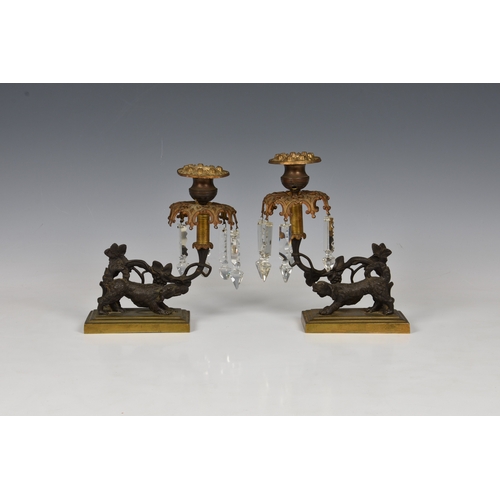 179 - A pair of 19th century patinated and gilt bronze lustre candlesticks the urn nozzles over pierced co... 