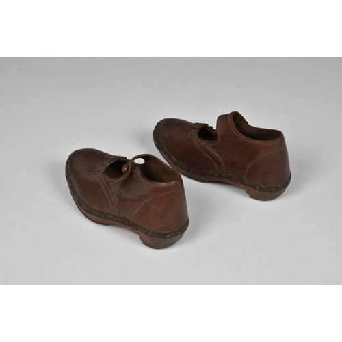 181 - A pair of antique brown leather child's clogs.