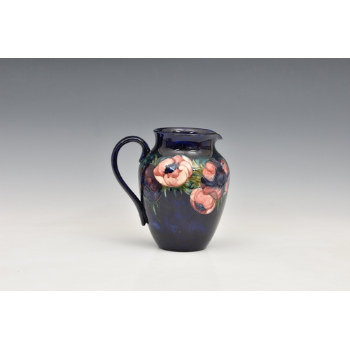 190 - A Moorcroft Pottery jug 'anemone' pattern, dark blue ground, , blue signature marks 'Potter to the Q... 