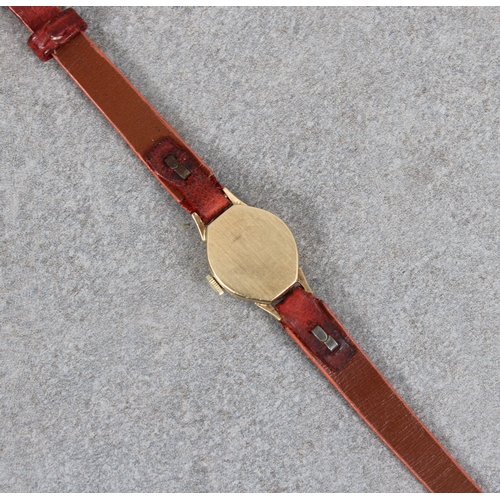 253 - A 9ct gold cased ladies Rotary small octagonal wrist watch with narrow leather strap.