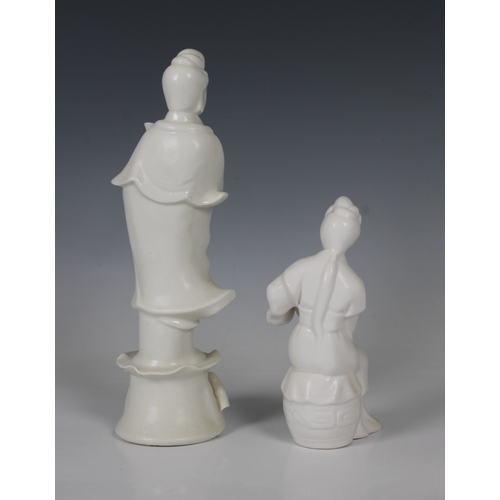 262 - Two blanc-de-chine porcelain Guanyin figures one holding a lotus flower, the other a stringed musica... 