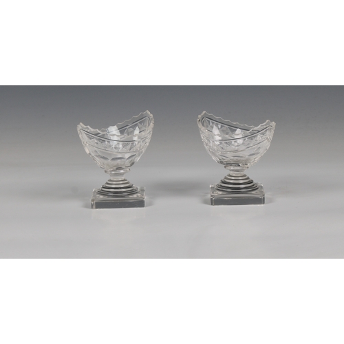 282 - A pair of Georgian navette shaped cut glass table salts on square bases, 3 1/4in. (8.3cm.) high.