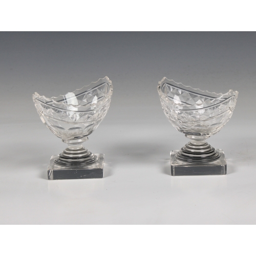 282 - A pair of Georgian navette shaped cut glass table salts on square bases, 3 1/4in. (8.3cm.) high.