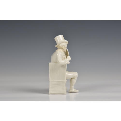 285 - A seated figure of a man in a top hat glazed white porcelain, 7½in. (19cm.) high.