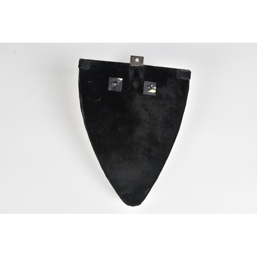 286 - A black velvet wall bracket incorporating a glazed white porcelain figure of a young woman in a grot... 