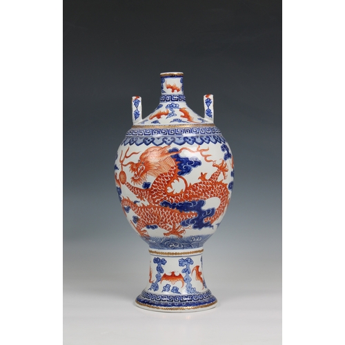 313 - A 19th century Chinese porcelain vase the ovoid body with rouge de feu and blue decoration of dragon... 