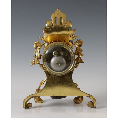 402 - A 19th Century French ormolu mantel clock of scrolling foliate form, surmounted with floral swags an... 