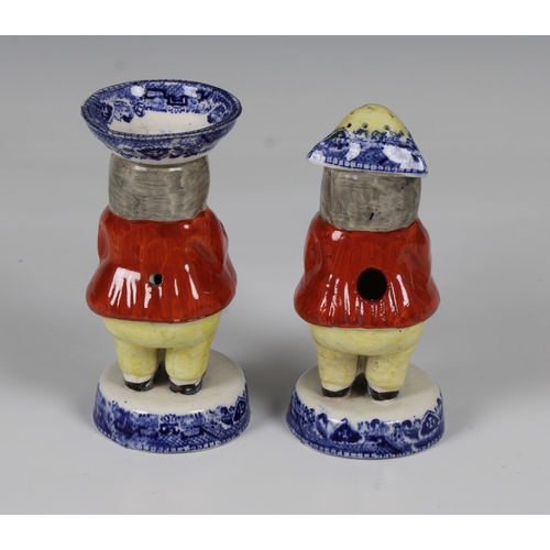 470 - A pair of Victorian Staffordshire salt and pepper condiments modelled as toby's, their hats and circ... 