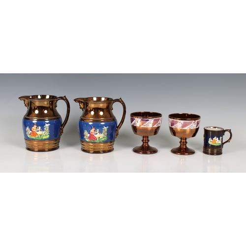 474 - A pair of English copper lustre jugs circa 1840, the central blue band sprig moulded with figures in... 