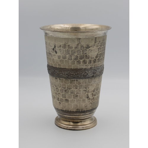 501 - A large silver footed beaker or vase with all over Honeycomb effect decoration with raised floral ba... 