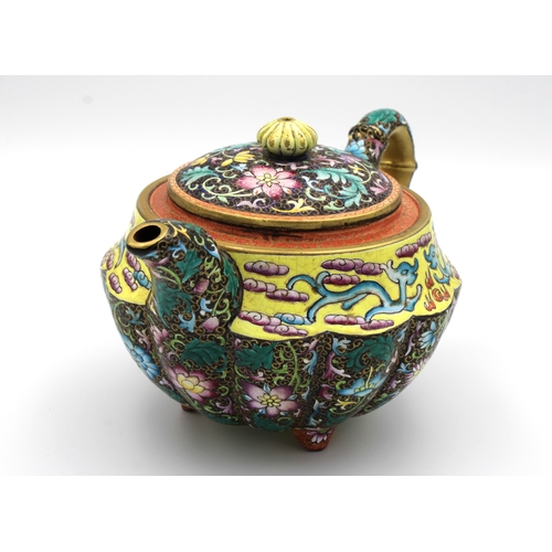 540 - A Chinese Yixing lobed teapot and cover painted in polychrome enamels depicting chrysanthemums and p... 