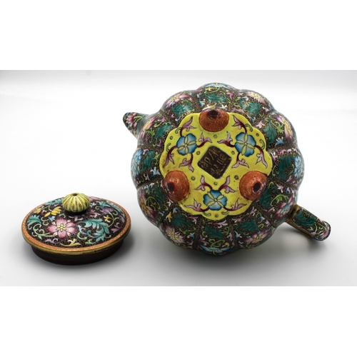 540 - A Chinese Yixing lobed teapot and cover painted in polychrome enamels depicting chrysanthemums and p... 