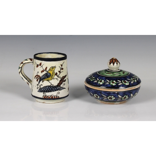 544 - Two pieces of Palestine pottery to include a circular box and cover with foliate decoration painted ... 