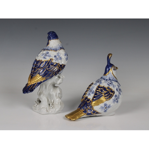 581 - A pair of Capodimonte bird figurines in blue & white with gilt highlights, the largest 21cm. high. (... 