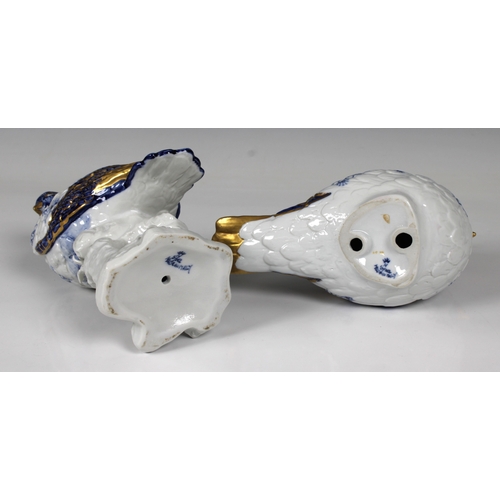 581 - A pair of Capodimonte bird figurines in blue & white with gilt highlights, the largest 21cm. high. (... 