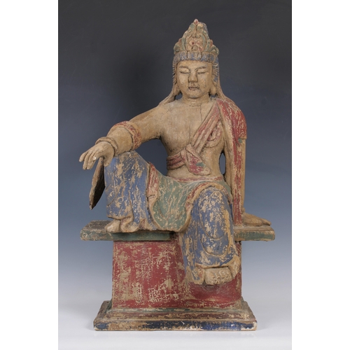 596 - A Chinese carved wood Buddha the polychrome figure on an integral base, approx. 75cm high