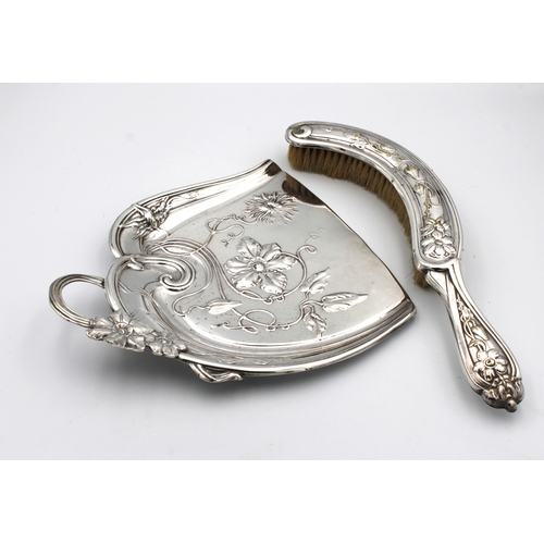 600 - An Art Nouveau silver plate crumb tray and brush of typical form with stylised floral & foliate deco... 