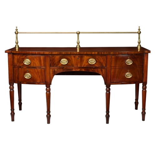 627 - An early 19th century breakfront mahogany sideboard the deep top with brass rail gallery to back, (o... 