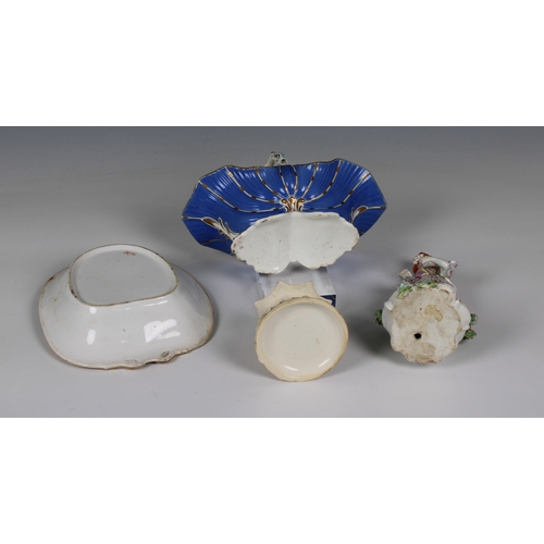 63 - A small collection of antique ceramics to include a Continental figure of a lady, standing against a... 