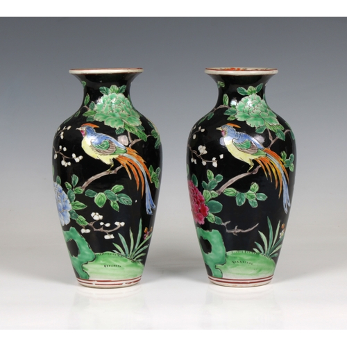 631 - A pair of 20th century Chinese famille noir style vases decorated with pheasants amongst flowering t... 