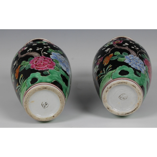 631 - A pair of 20th century Chinese famille noir style vases decorated with pheasants amongst flowering t... 