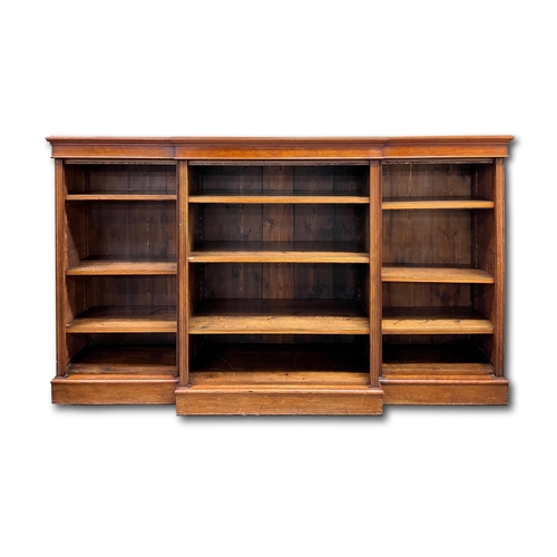 639 - A Victorian mahogany breakfront open bookcase of three compartments, each with three shelves, 218cm.... 