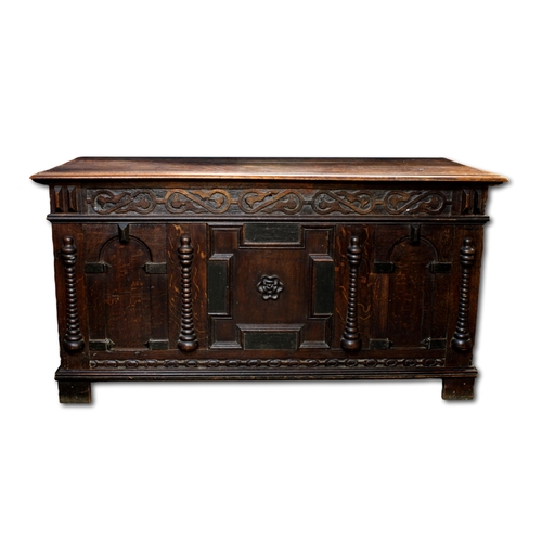 645 - A large 18th / 19th century heavily carved oak coffer the front with turned columns and ornate carvi... 