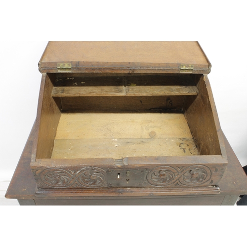 652 - A 17th Century carved oak bible box The hinged rectangular top above four panels carved with sun mot... 