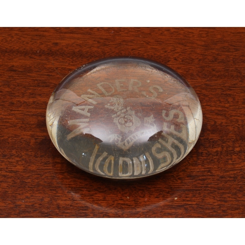 75 - A clear glass advertising paperweight early 20th century, for 'Mander's Varnishes', 8cm. diameter.