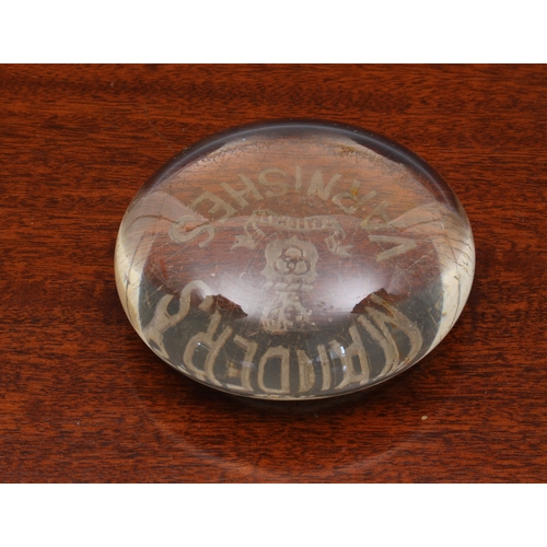 75 - A clear glass advertising paperweight early 20th century, for 'Mander's Varnishes', 8cm. diameter.