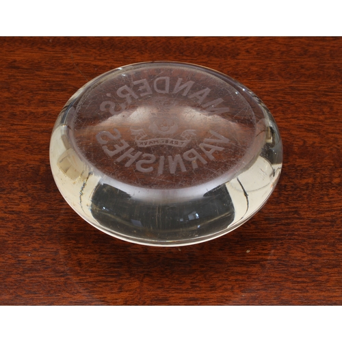 75 - A clear glass advertising paperweight early 20th century, for 'Mander's Varnishes', 8cm. diameter.