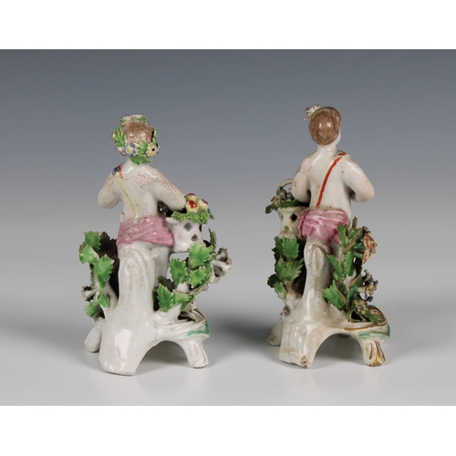 8 - A pair of Chelsea-Bow porcelain bocage figures, late 18th century each carrying baskets of fruit and... 